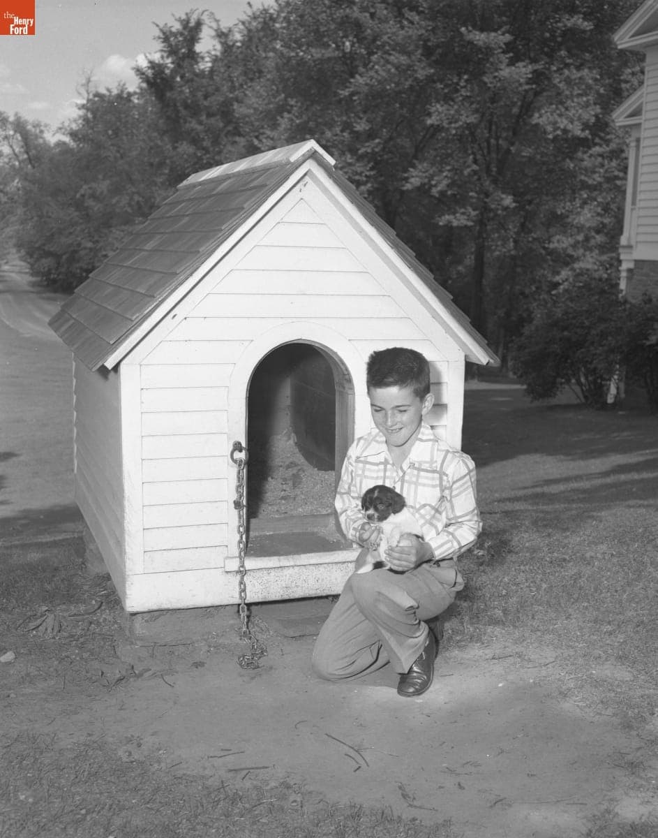 Boy Holding "Old Dog Tray" in Greenfield Village, 1951-1952