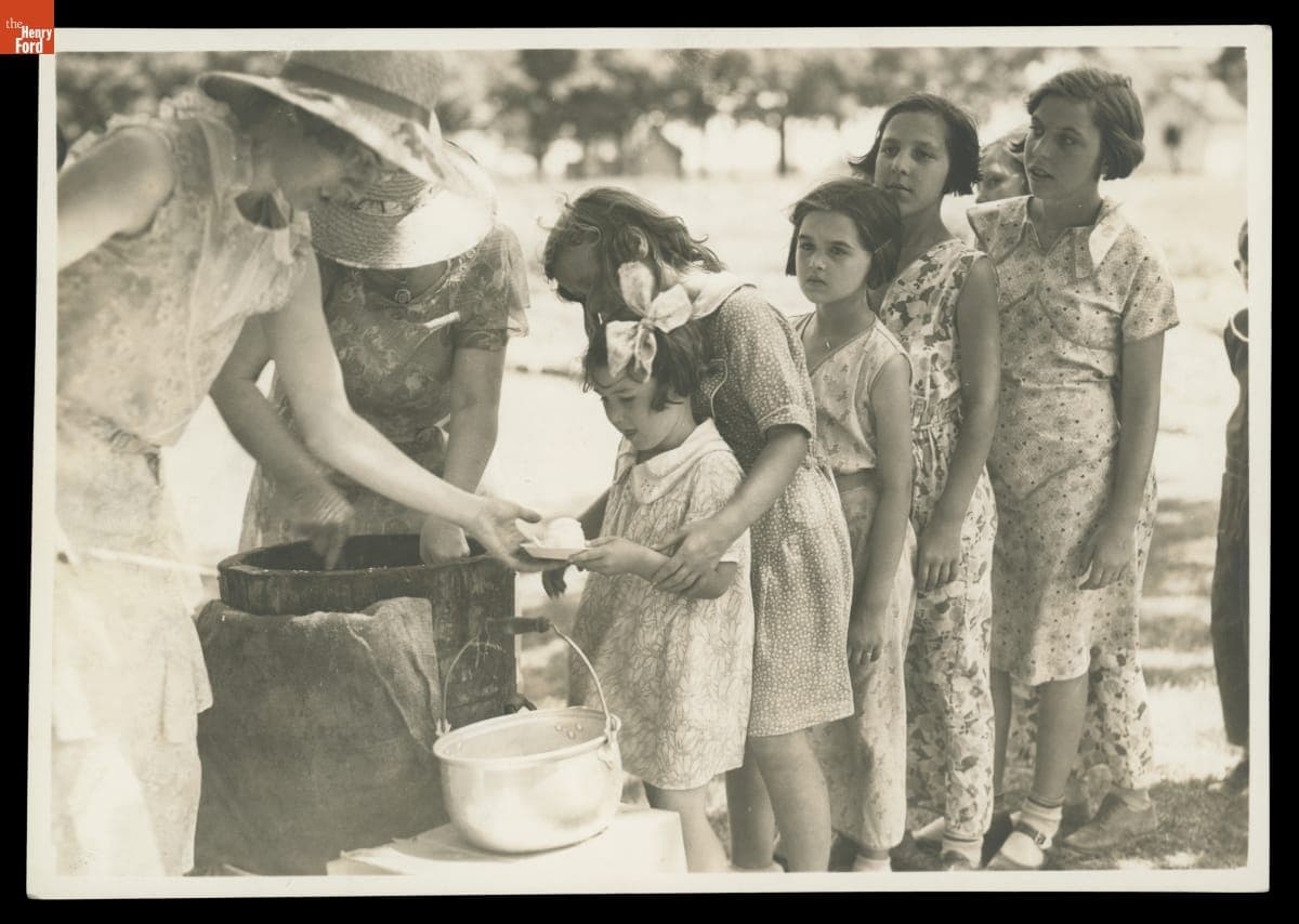Students Waiting in Line for Ice Cream Outdoors at Town School, Macon, Michigan