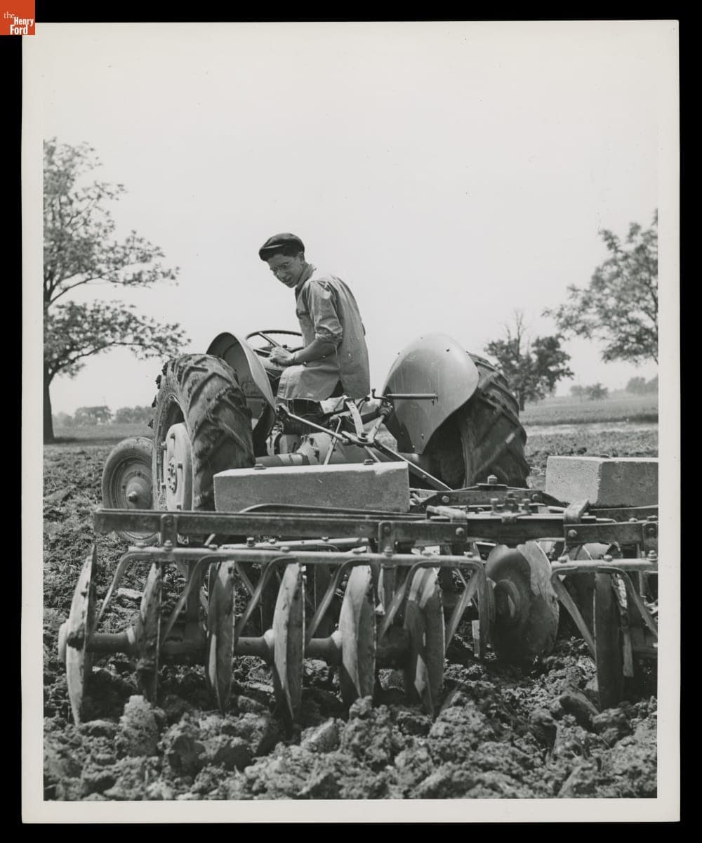 Macon (Michigan) High School Student Max Camburn Driving a Ford 9N Tractor with Disc, May 1944