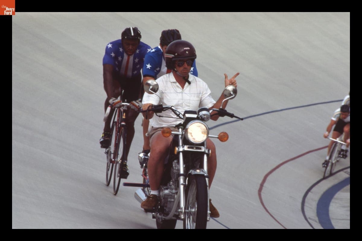 Motorcyclist Riding Ahead of Bicyclists at the 1984 Los Angeles Summer Olympics