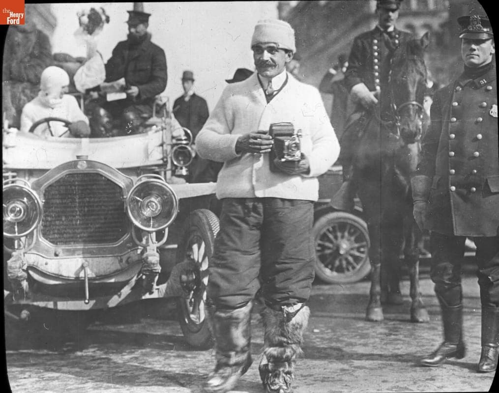 De Dion-Bouton Mechanic Alphonse Autran with Camera before the New York to Paris Race, New York City, 1908