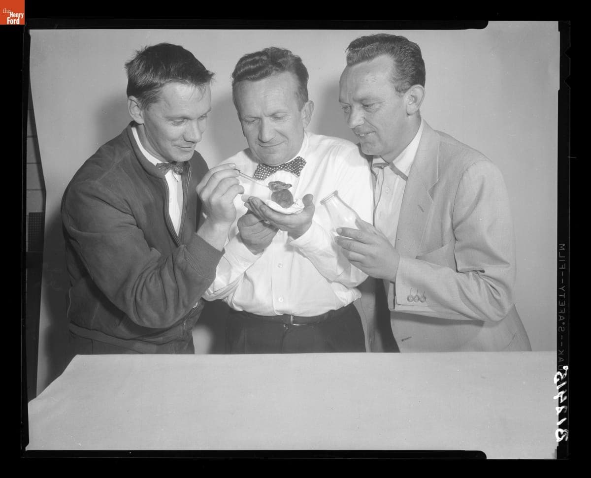 Charles White, Gus Munchow, and Edmond Miezcur Feeding a Baby Rabbit, May 10, 1956