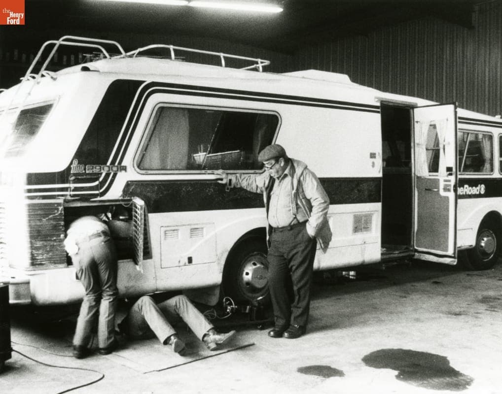 Charles Kuralt Watching Mechanics Repairing the CBS "On the Road" Motor Home, circa 1987