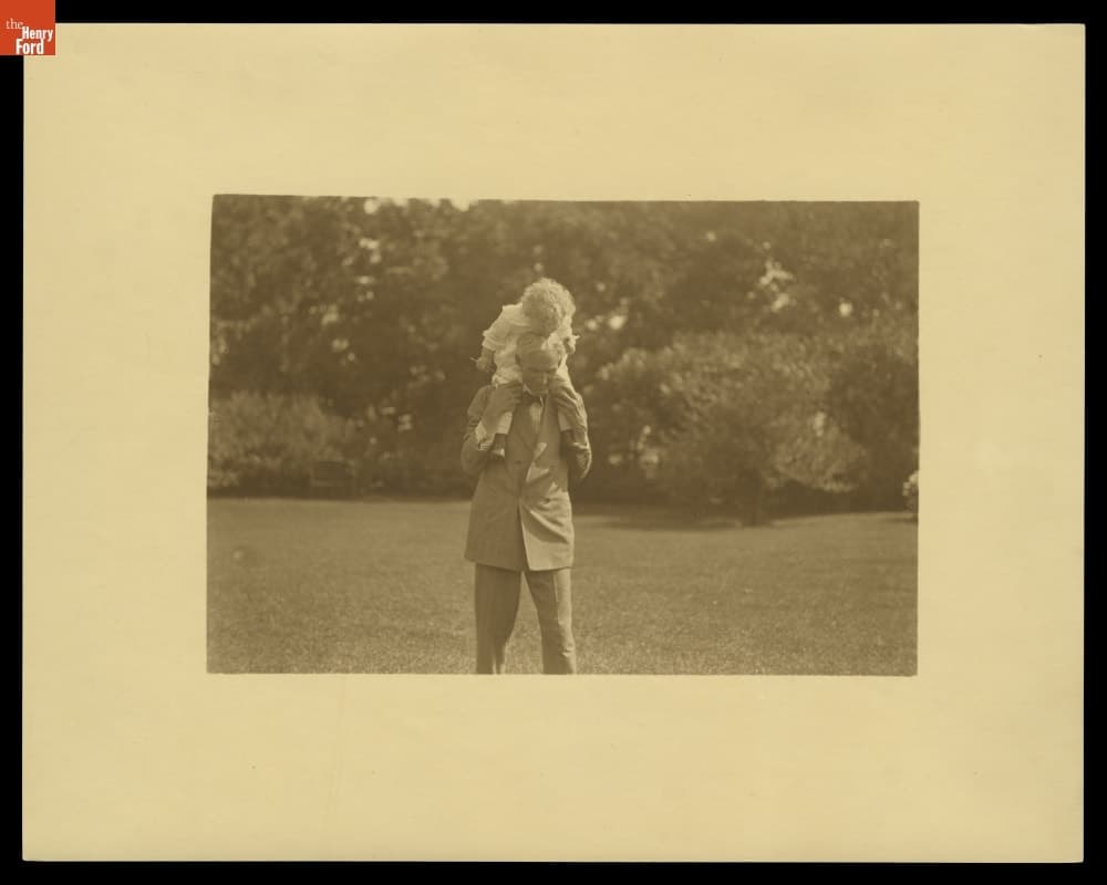 Henry Ford Carrying Grandson Henry Ford II at Fair Lane, Dearborn, Michigan, 1919