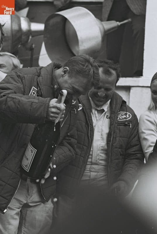 Dan Gurney and A. J. Foyt with Victory Champagne at the 24 Heures du Mans (24 Hours of Le Mans) Race, June 1967