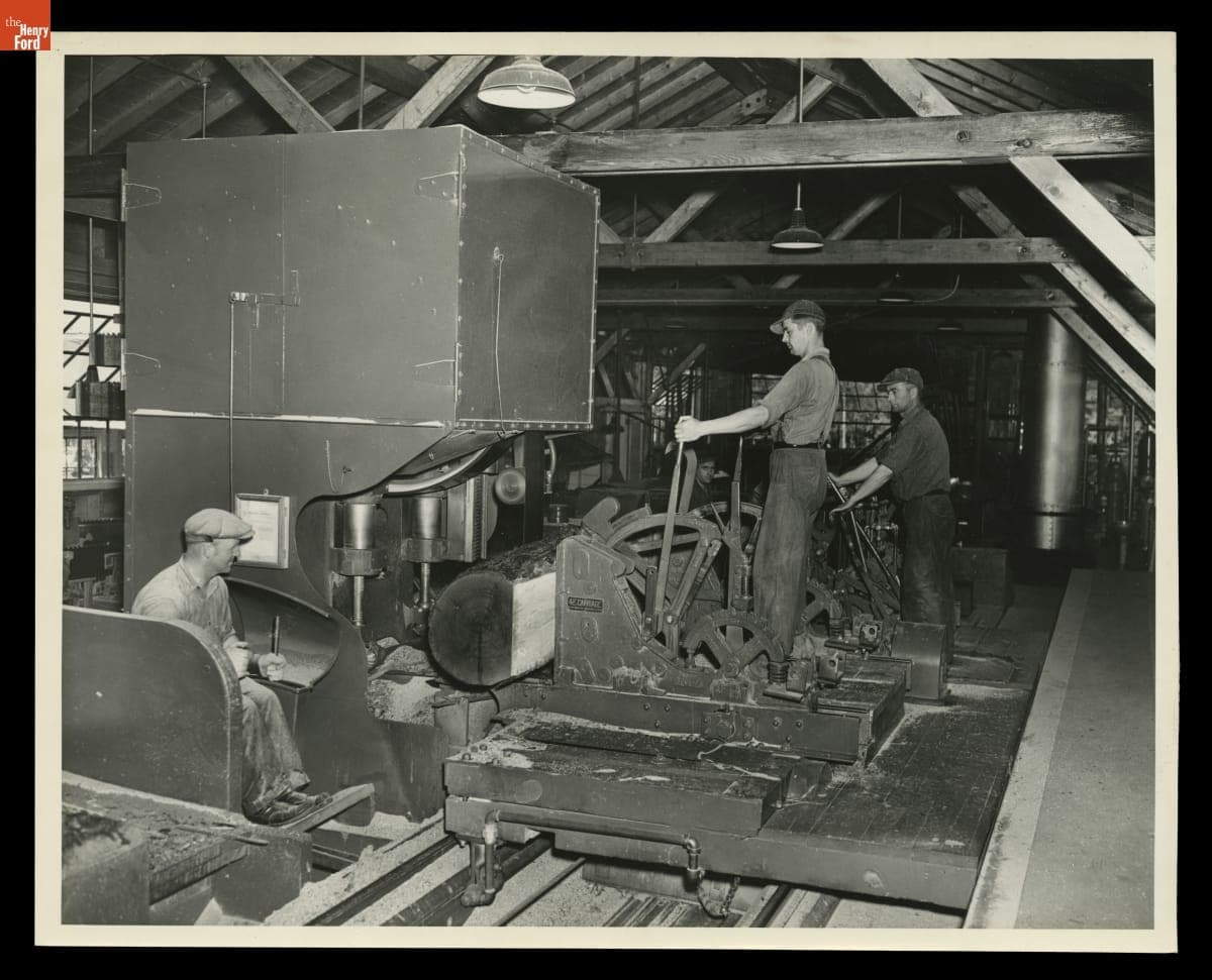 Workers Operate a Log Carriage inside a Sawmill in Alberta, Michigan, 1937