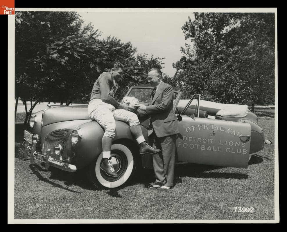 Auto Dealer Stark Hickey and Detroit Lions Player Clem Crabtree with a 1941 Lincoln Zephyr