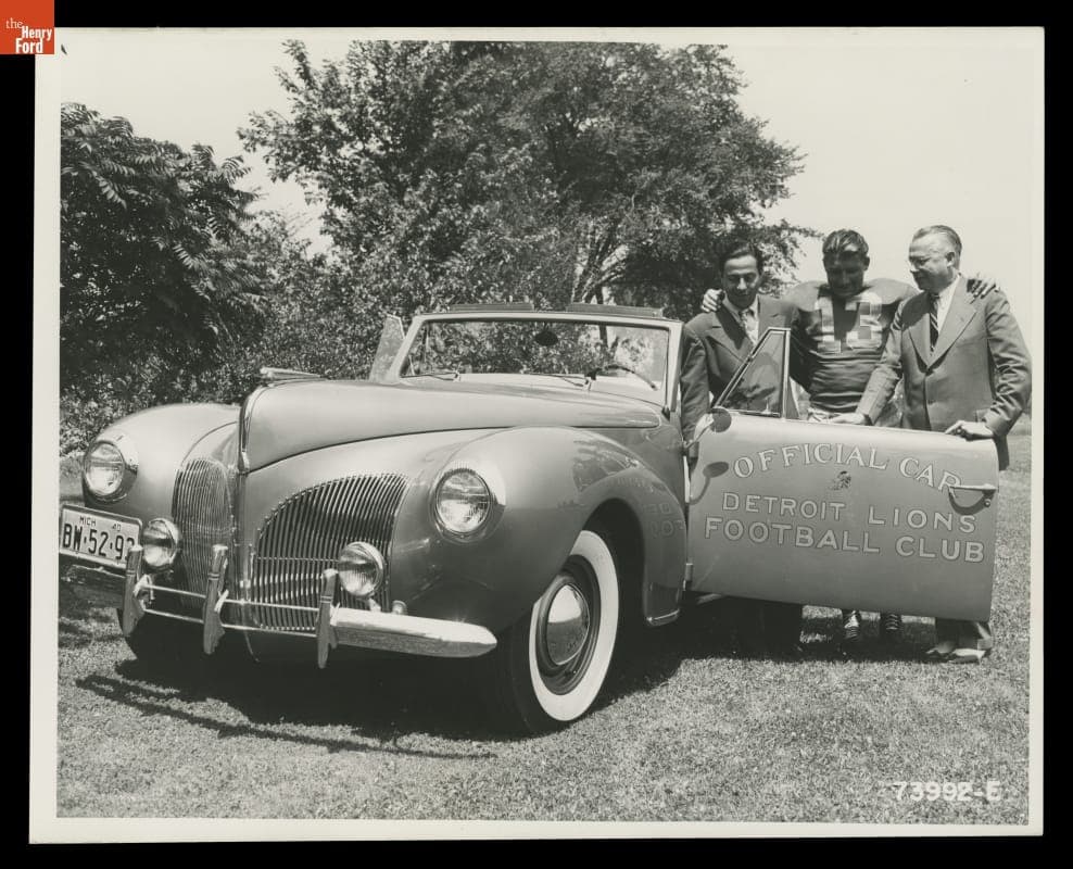 Auto Dealer Stark Hickey (right) and Detroit Lions Player Clem Crabtree with a 1941 Lincoln Zephyr