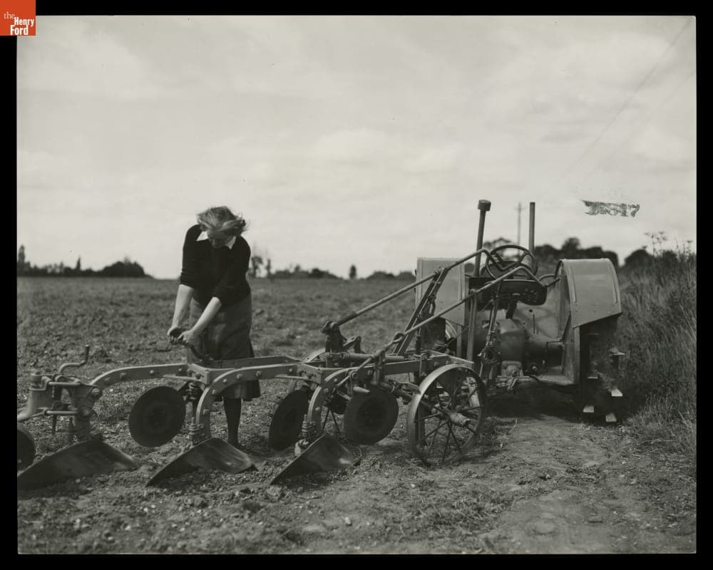 Woman Working on a Plow Hooked to a Tractor at Henry Ford Institute of Agricultural Engineering, England, 1939