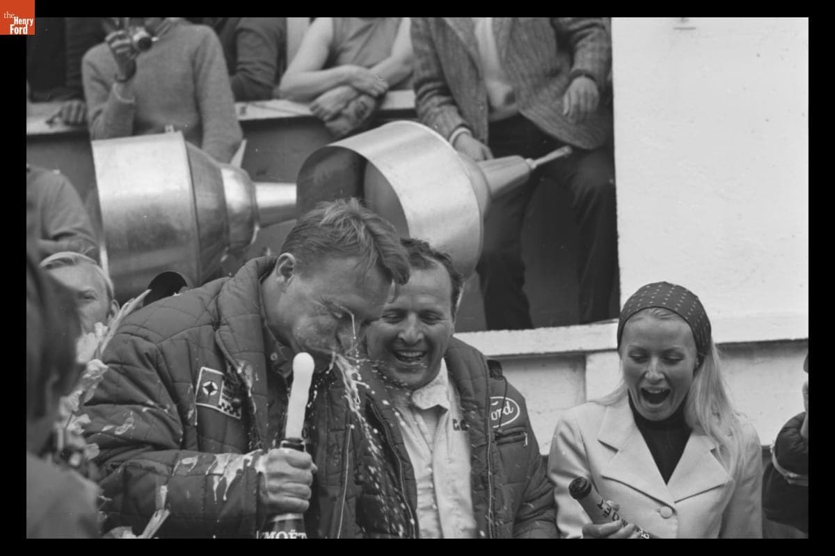 Dan Gurney and A. J. Foyt with Victory Champagne at the 24 Heures du Mans (24 Hours of Le Mans) Race, June 1967