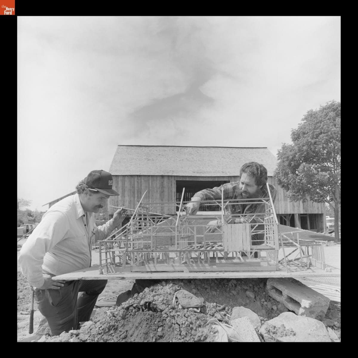 Blake Hayes with a Model of Firestone Barn Used during Its Reconstruction in Greenfield Village, May 1985