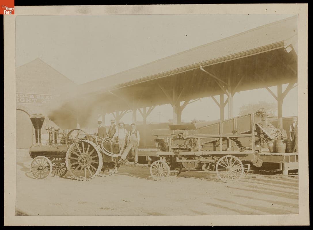 Men Standing with Traction Engine and Grain Separator at Freight Station, 1896