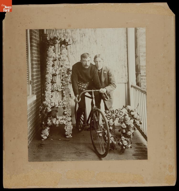 Cyclist Albert Schock Seated on Bicycle With Floral Tribute, circa 1890