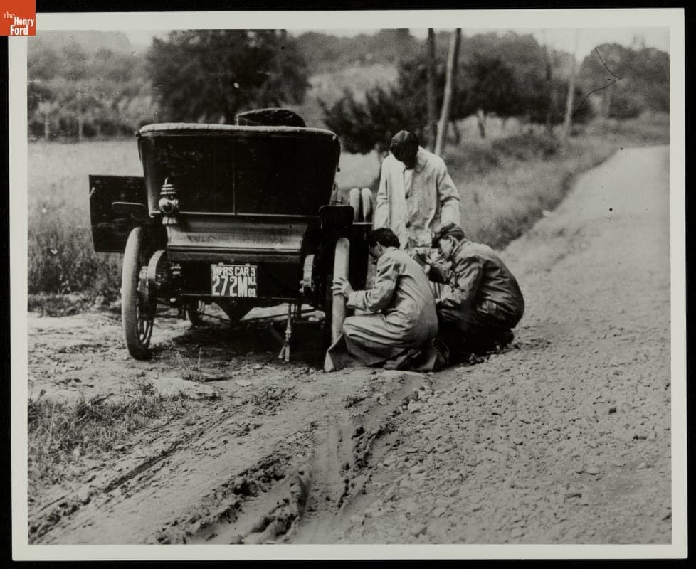 Three Men Examining Tire on Ford Model T Car, 1909