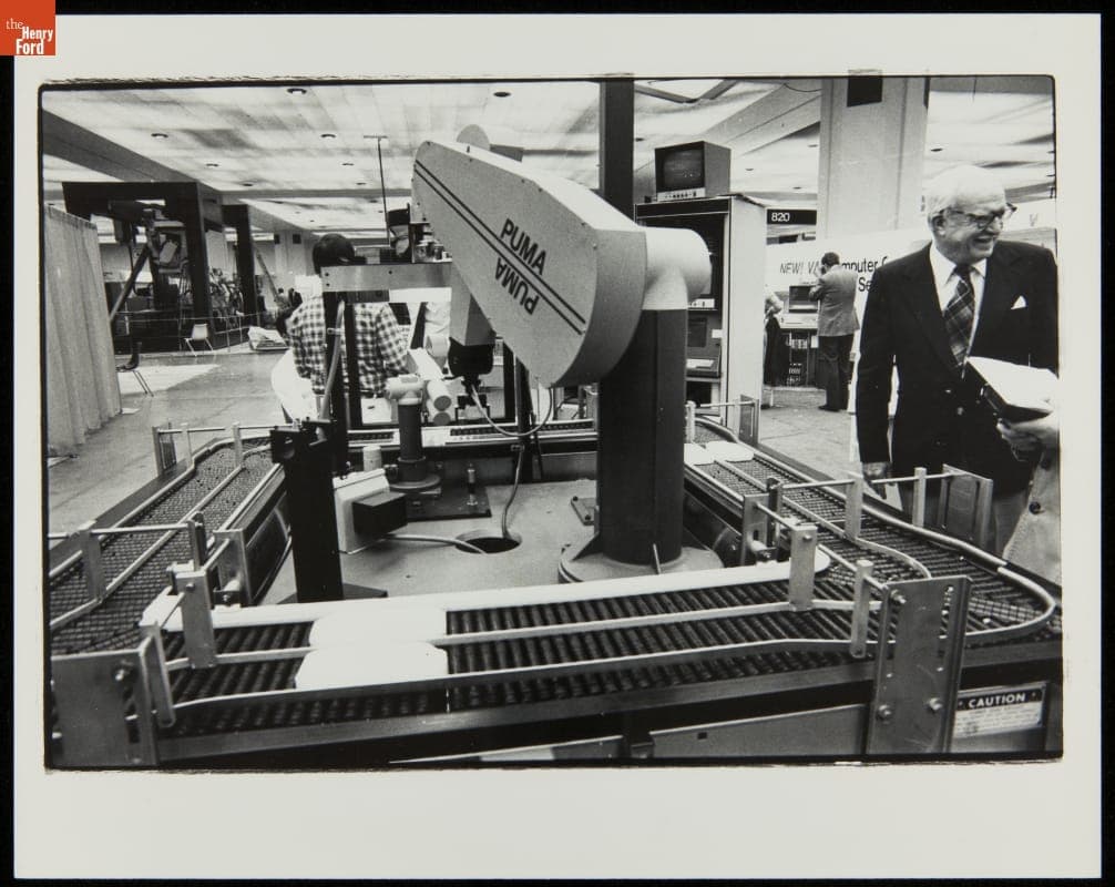 George Devol with a Programmable Universal Machine for Assembly (PUMA), 1979-1982