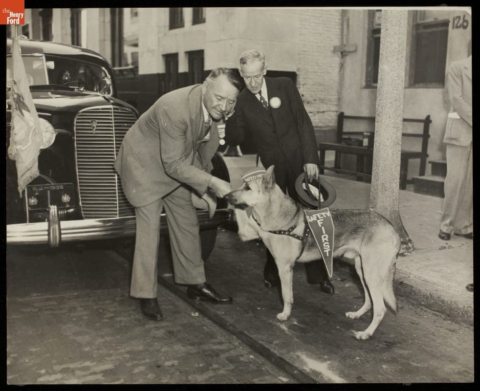 Barney Oldfield Greeting a "Safety First" Dog, New Jersey, 1936