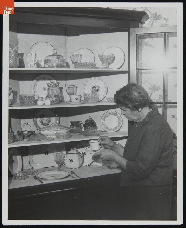 Catherine Ake, Granddaughter of Catherine Flickinger Firestone, Examines Wedding China Given to her Grandmother, 1965