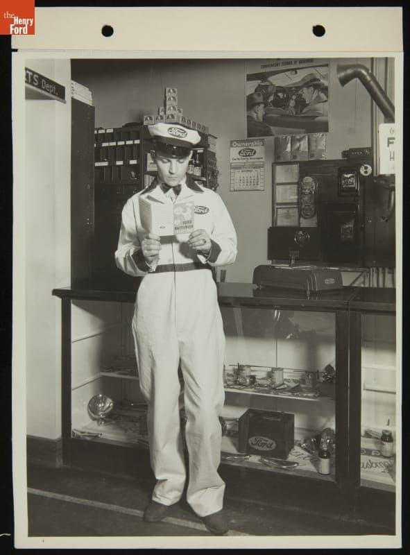 Ford Service Station Attendant Reading about Ford Batteries, December 1934
