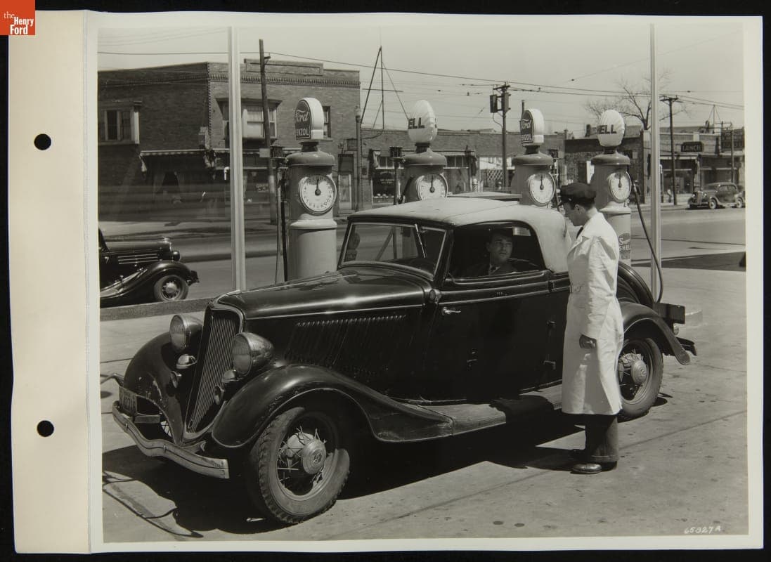 Service Station Attendant Talking to Driver near Fuel Pumps, April 1936