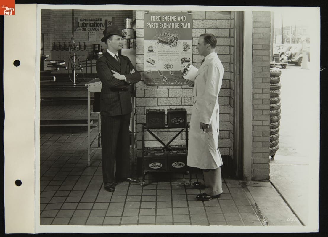 Service Station Attendant and Customer Discuss Ford Engine and Parts Exchange Plan, 1936