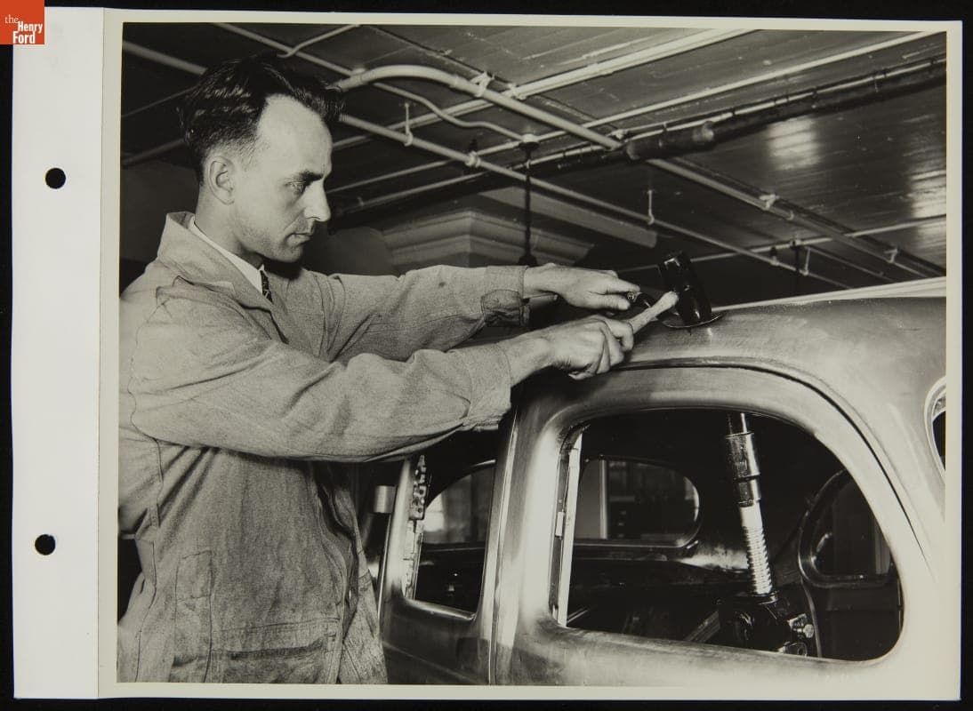 Mechanic in Service Garage Using Bumping Tools with Pneumatic Jack, May 1937