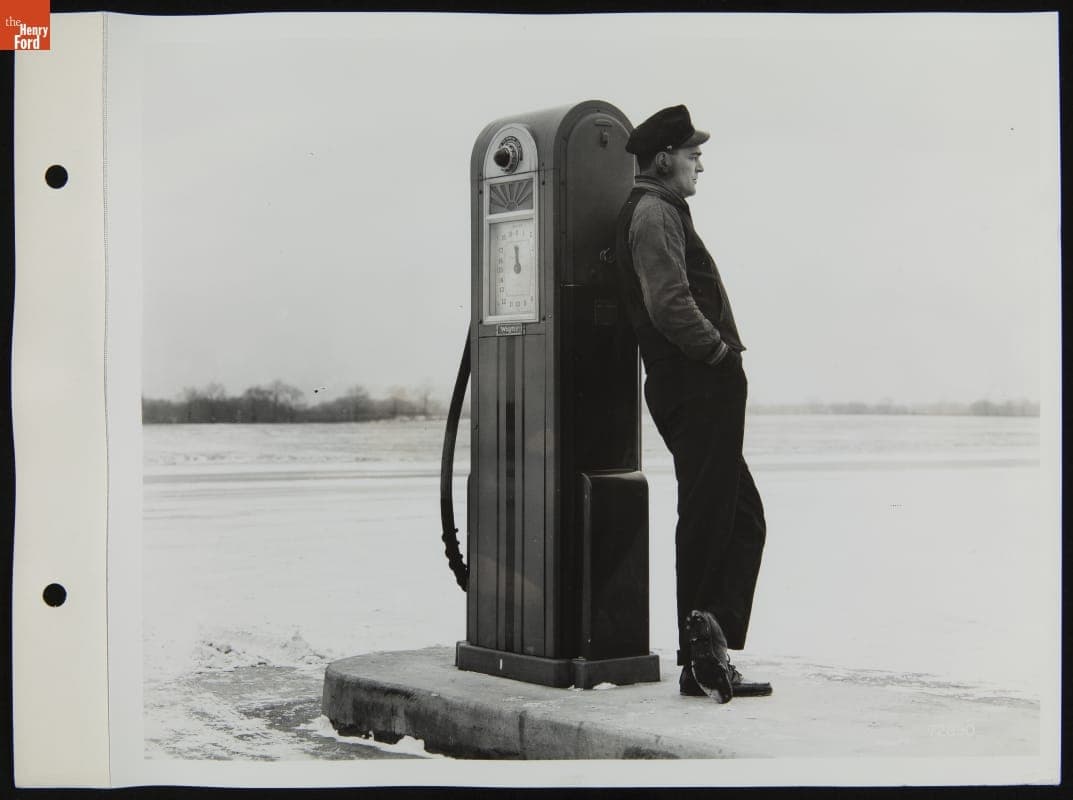 Gas Station Attendant Standing at Fuel Pump, January 1940