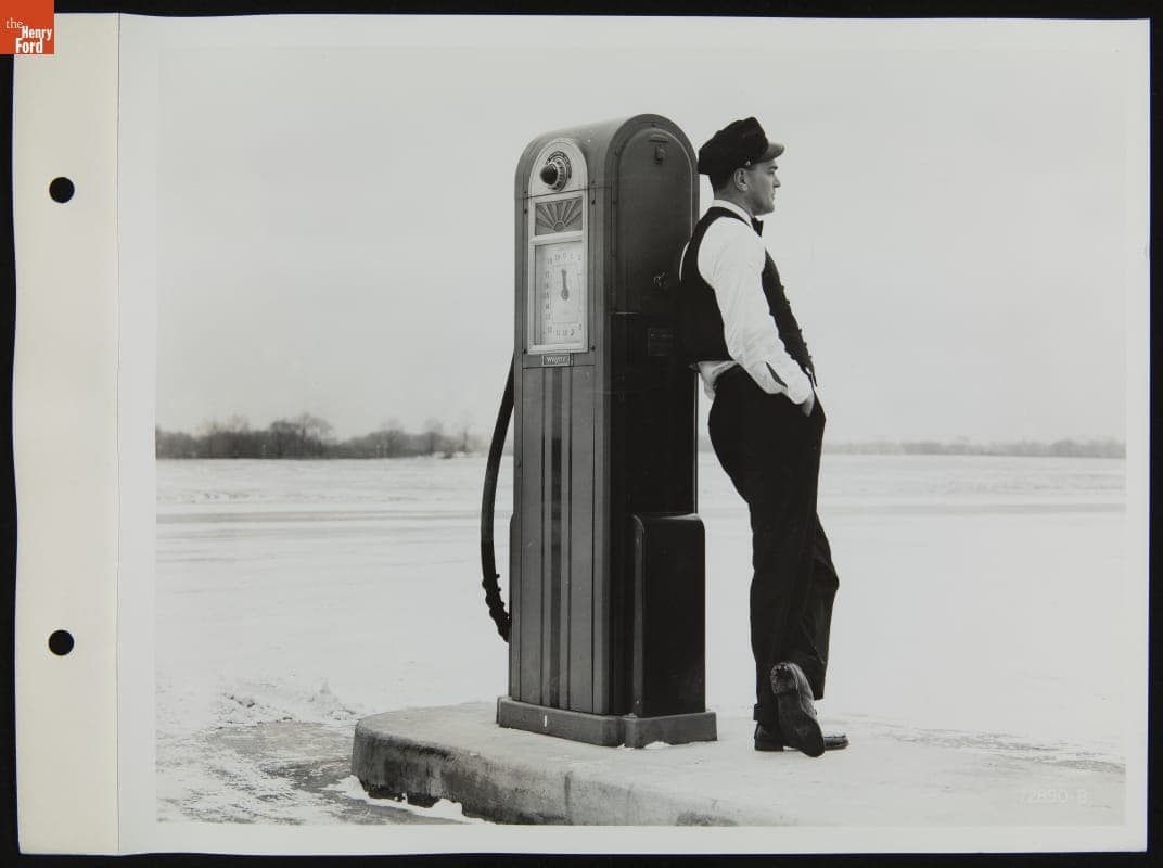 Gas Station Attendant Standing at Fuel Pump, January 1940