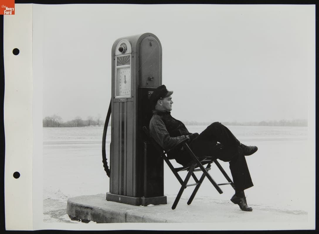 Gas Station Attendant Seated at Fuel Pump, January 1940