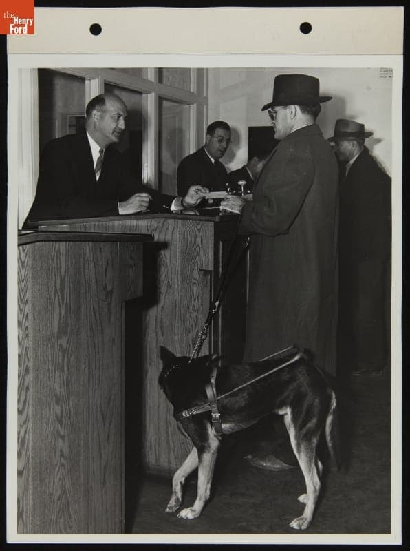 Ford Employee Sylvester Rypkowski Checking into Work with His Service Dog "Blackie," October 1942