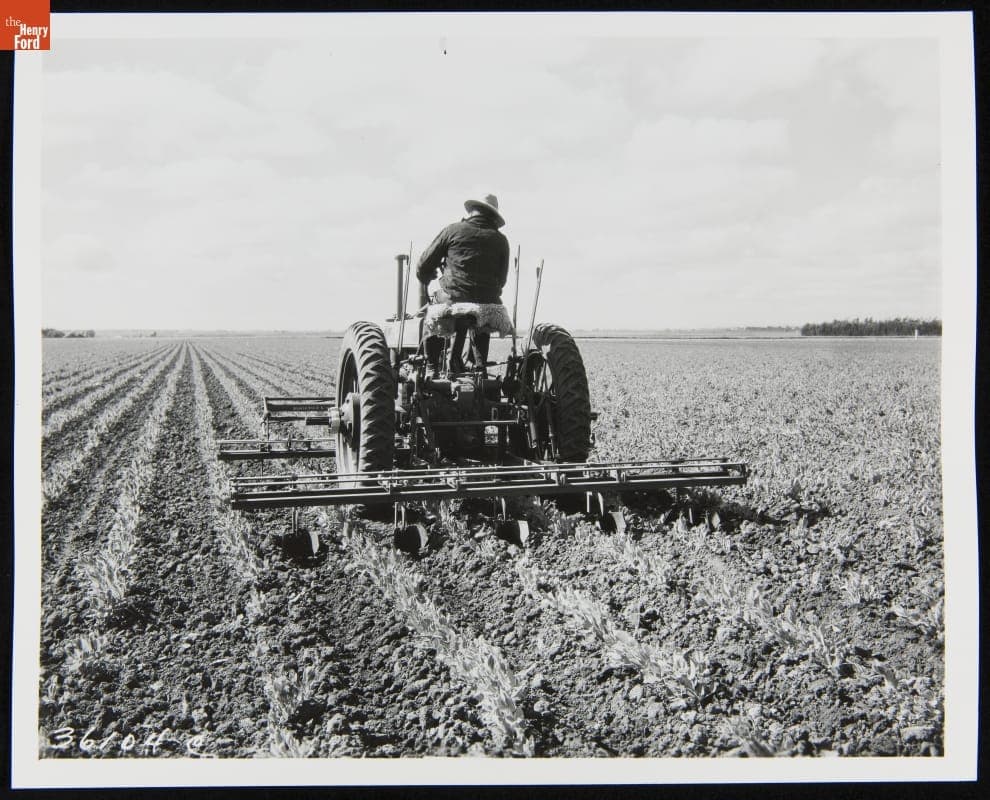 Man Using a 1935-1938 John Deere Model "B" Series Tractor