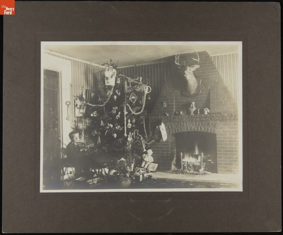 Little Boy in a Toy Car near a Christmas Tree with More Toys, 1905