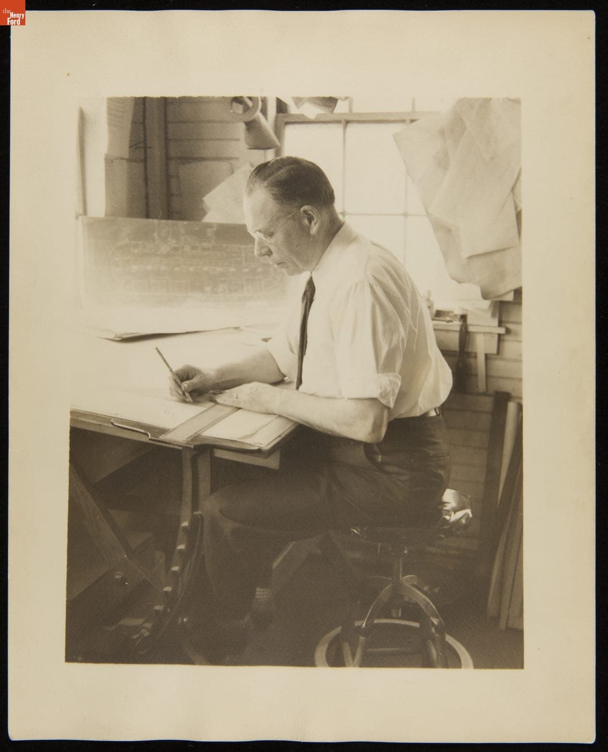 Merritt McConnell, Senior Draftsman for the J.B. Judkins Company, Seated at Desk, circa 1940