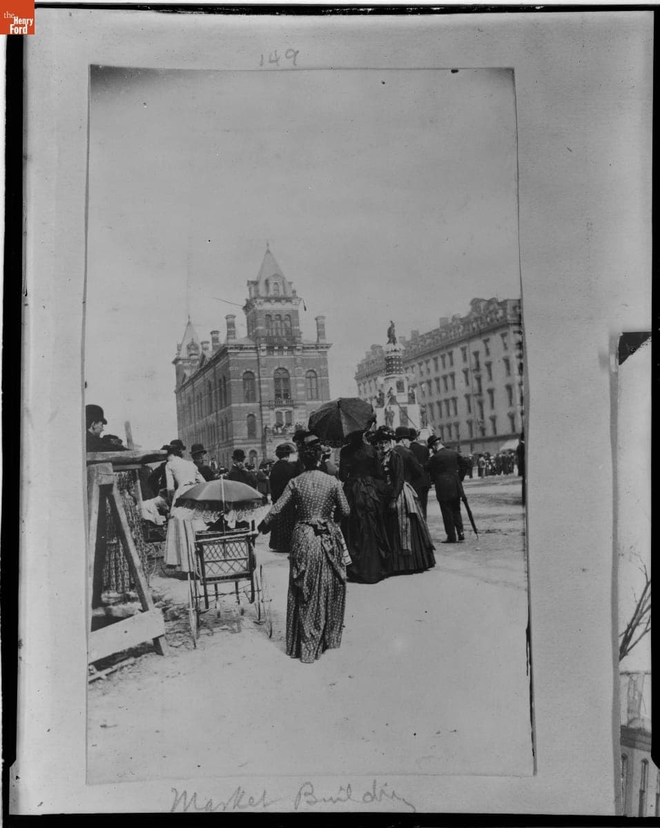 Group of Women, One with a Baby Carriage, in front of the Central Market Building, Detroit, Michigan, circa 1890