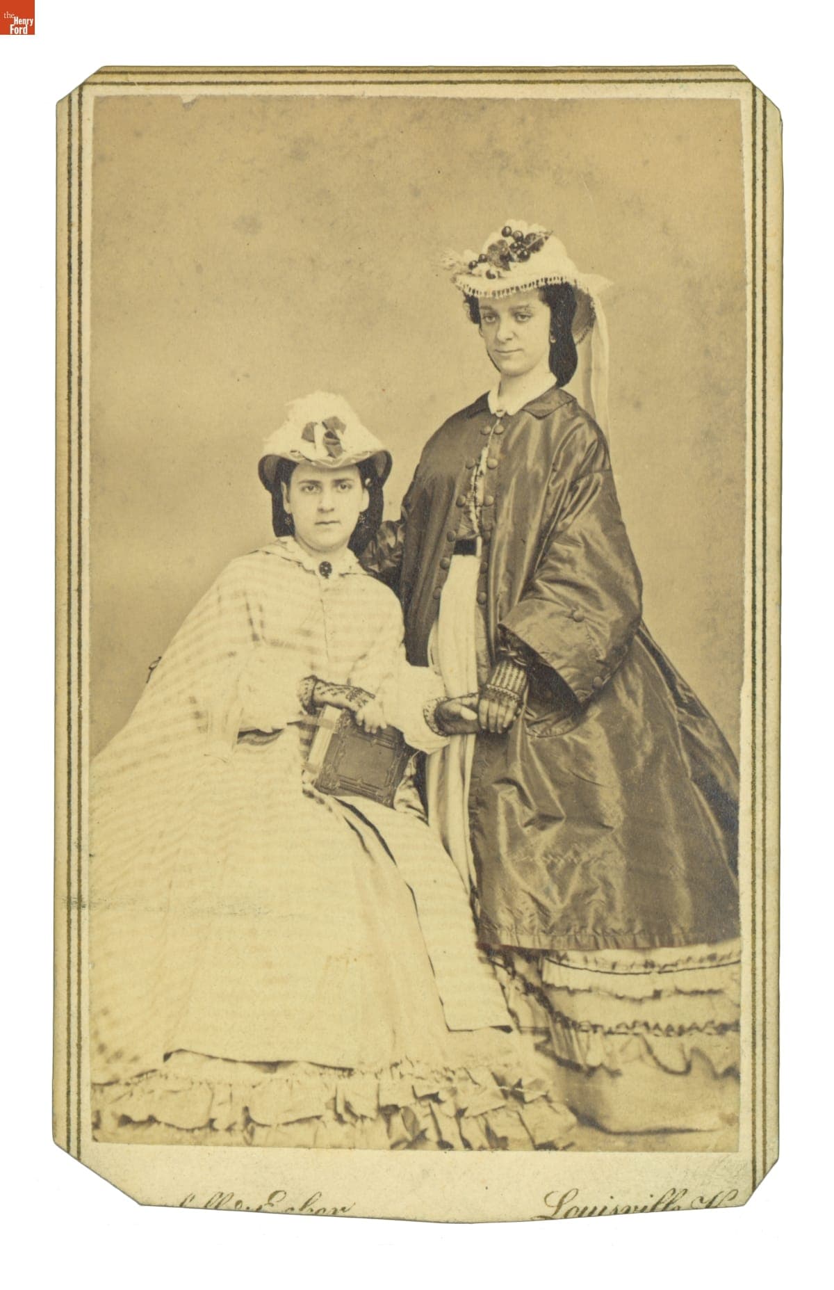 Two Young Women Wearing Cloaks and Hats, circa 1865