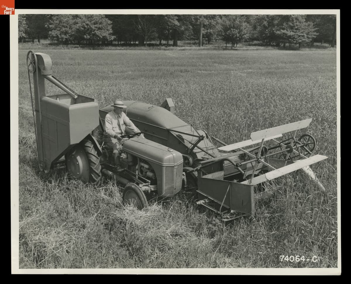 Man Driving a Ford-Ferguson Tractor with Combine Attached, August 1940