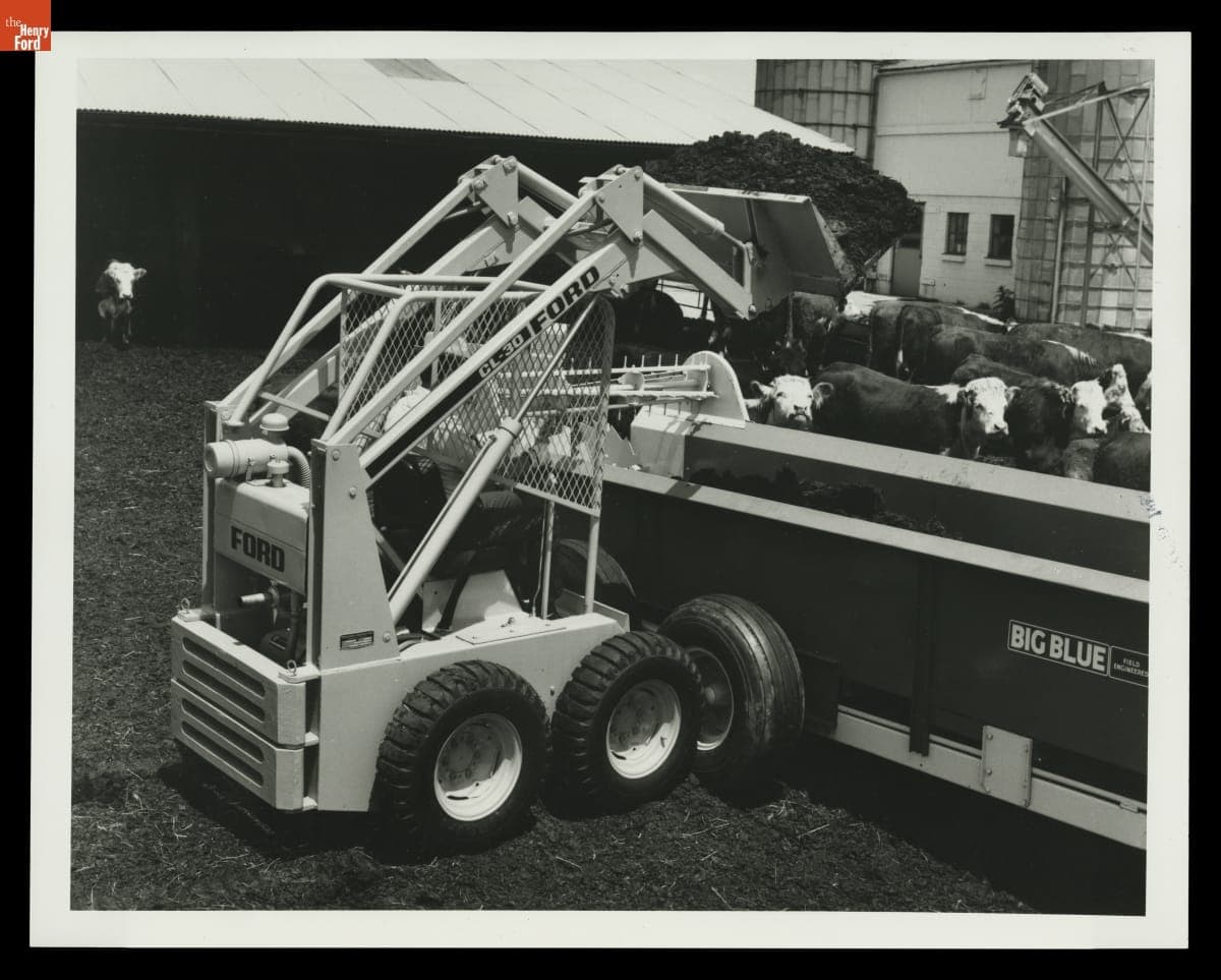 Ford Motor Company Model CL-30 Compact Loader Filling a Manure Spreader, 1974