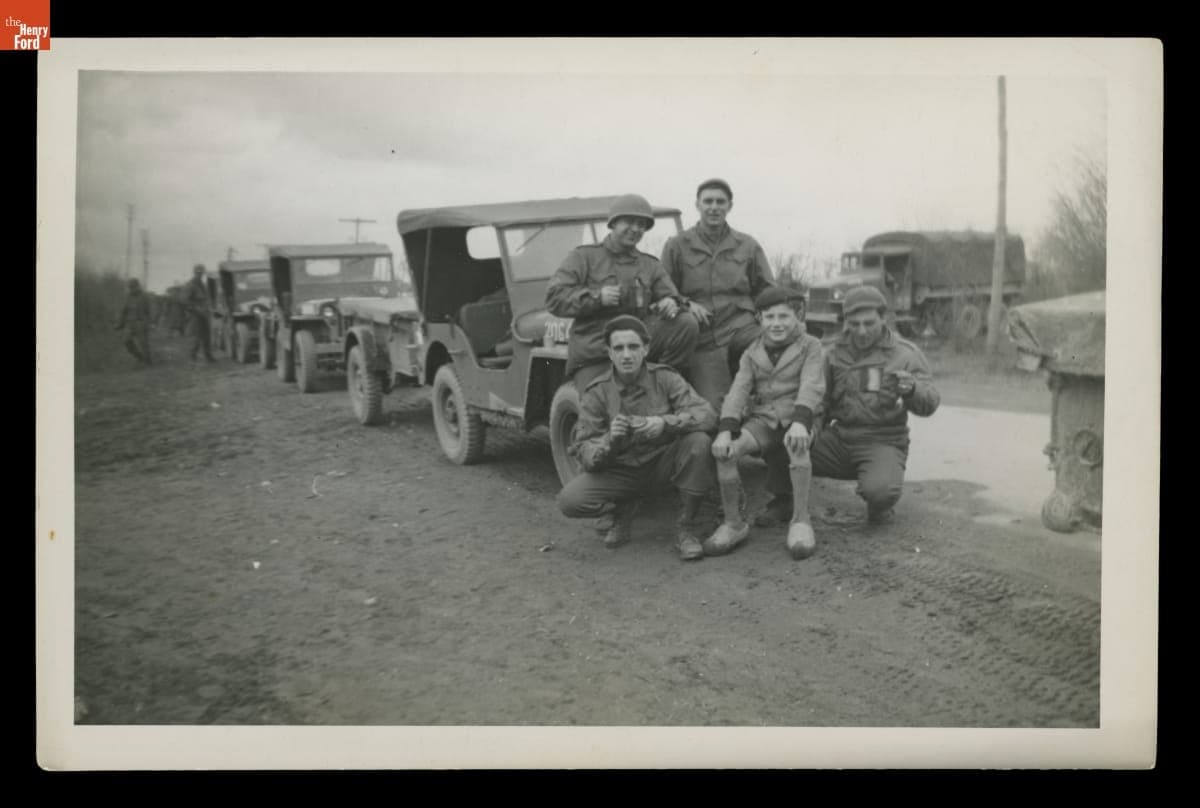 Young Boy with U.S. Army Personnel and Jeeps, France, 1945