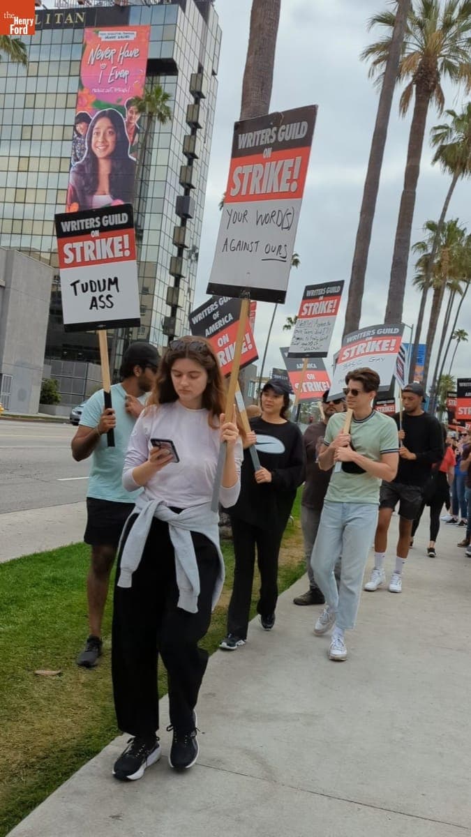 Writers Guild of America Picket Line with Picketers Holding Signs Referring to Netflix Leadership, June 3, 2023