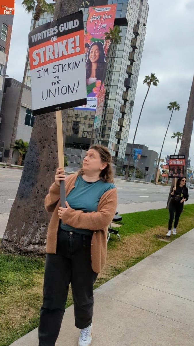 Writers Guild of America Strike Picketer Holding Sign that Reads "I'm Stickin' to the Union," June 3, 2023