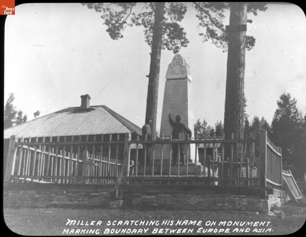 "Miller Scratching His Name on Monument Marking Boundary Between Europe and Asia," New York to Paris Race, 1908
