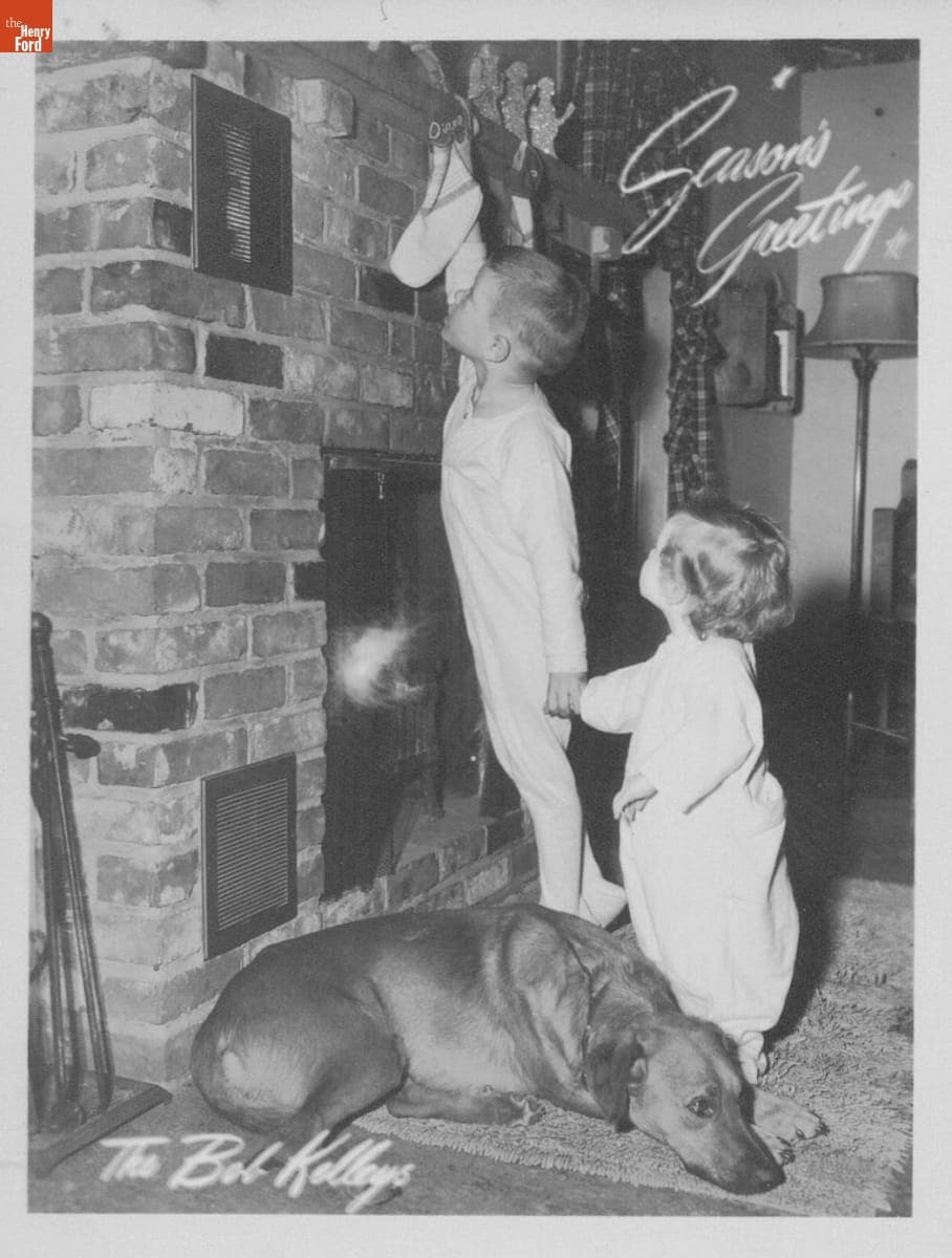 Kelley Family Christmas Card, Bobby Hanging Diane's Stocking, December 1949