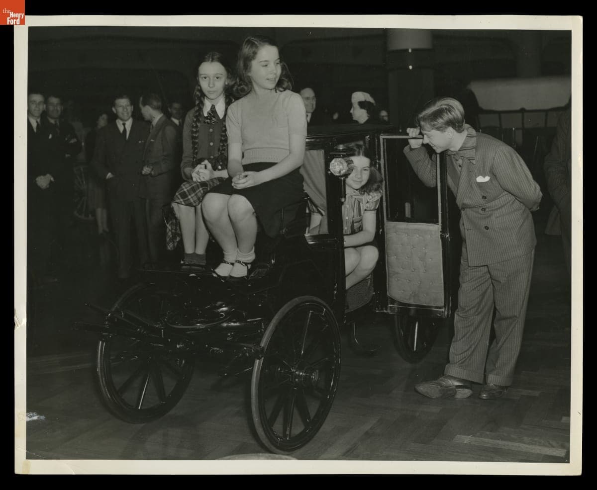 Mickey Rooney and Students from the Edison Institute Schools with the Tom Thumb Carriage in Henry Ford Museum, 1940