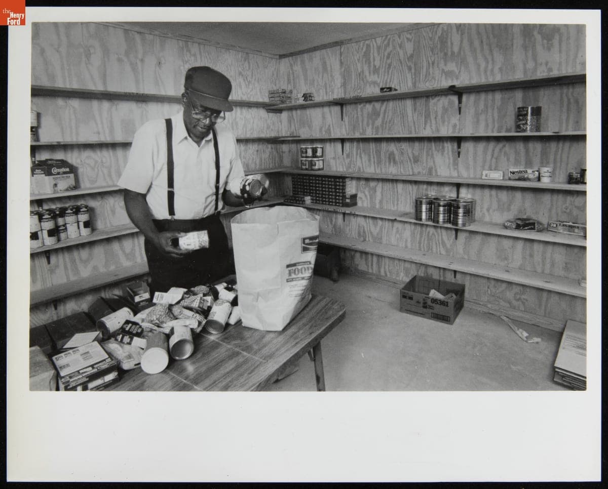 The Reverend Moses Owens of Mt. Olive Church Loads a Bag with Donated Food, October 1988