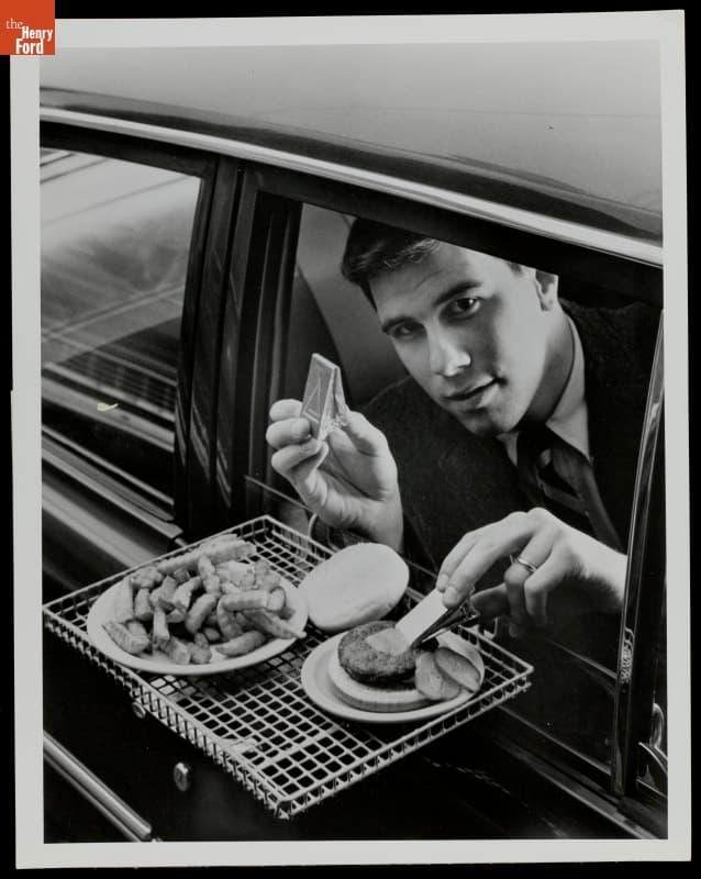 Spreading Mustard on a Hamburger at a Drive-In Restaurant, circa 1965