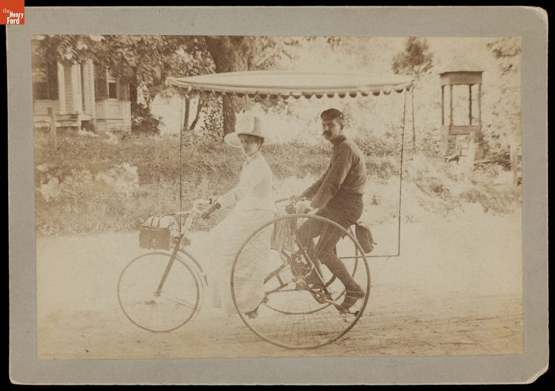 Couple on a Columbia Tandem Tricycle with Canopy, 1887