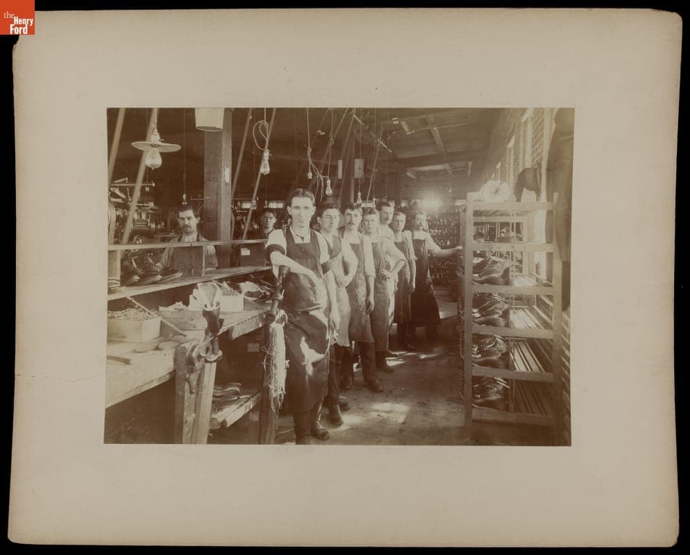 Shoe Factory Workers Posing near Rows of Completed Footwear, Boston, Massachusetts, circa 1903