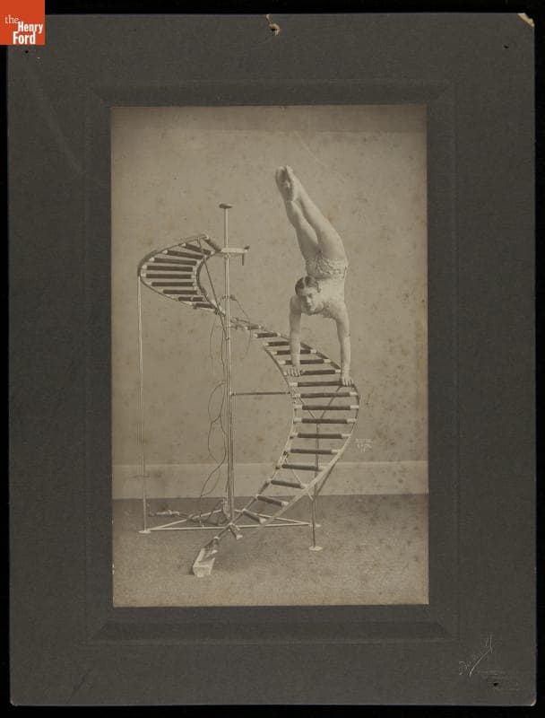 Gymnast Performing a Handstand on a Spiral Step, circa 1915