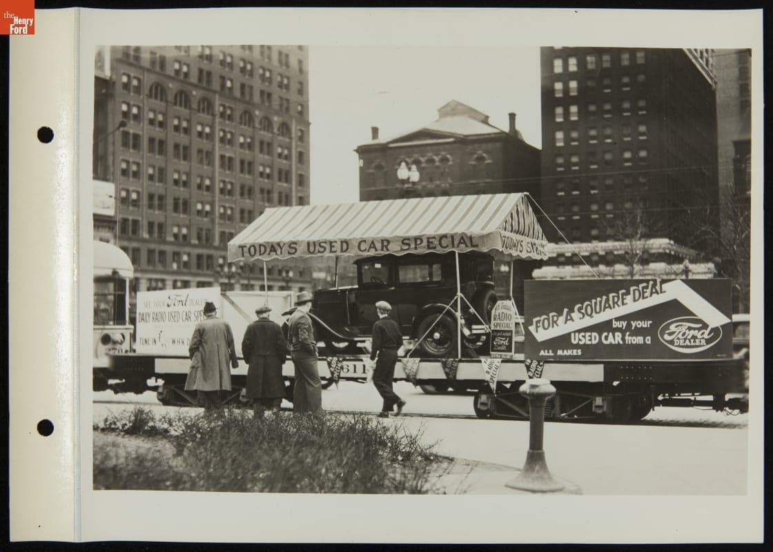 Used Car Displayed on Platform Trailer Behind Street Car, May 1935