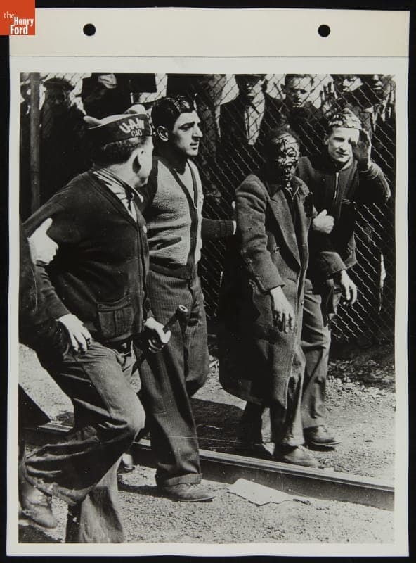 UAW Strikers Walk With Beaten Workman, April 1941