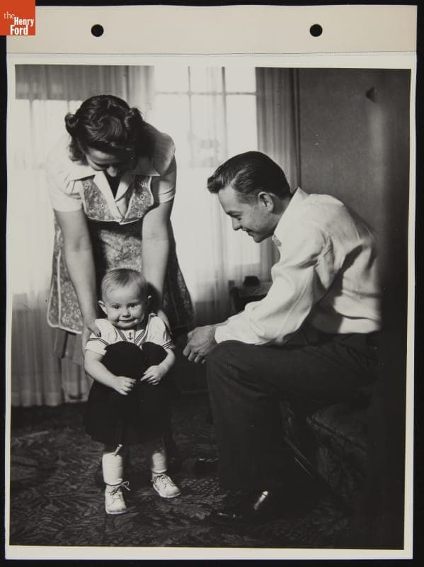 Mrs. Anderson, a Willow Run Bomber Plant Employee, at Home with Her Husband and Child, February 1943